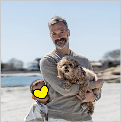 Greg with his son and their maltipoo at the beach